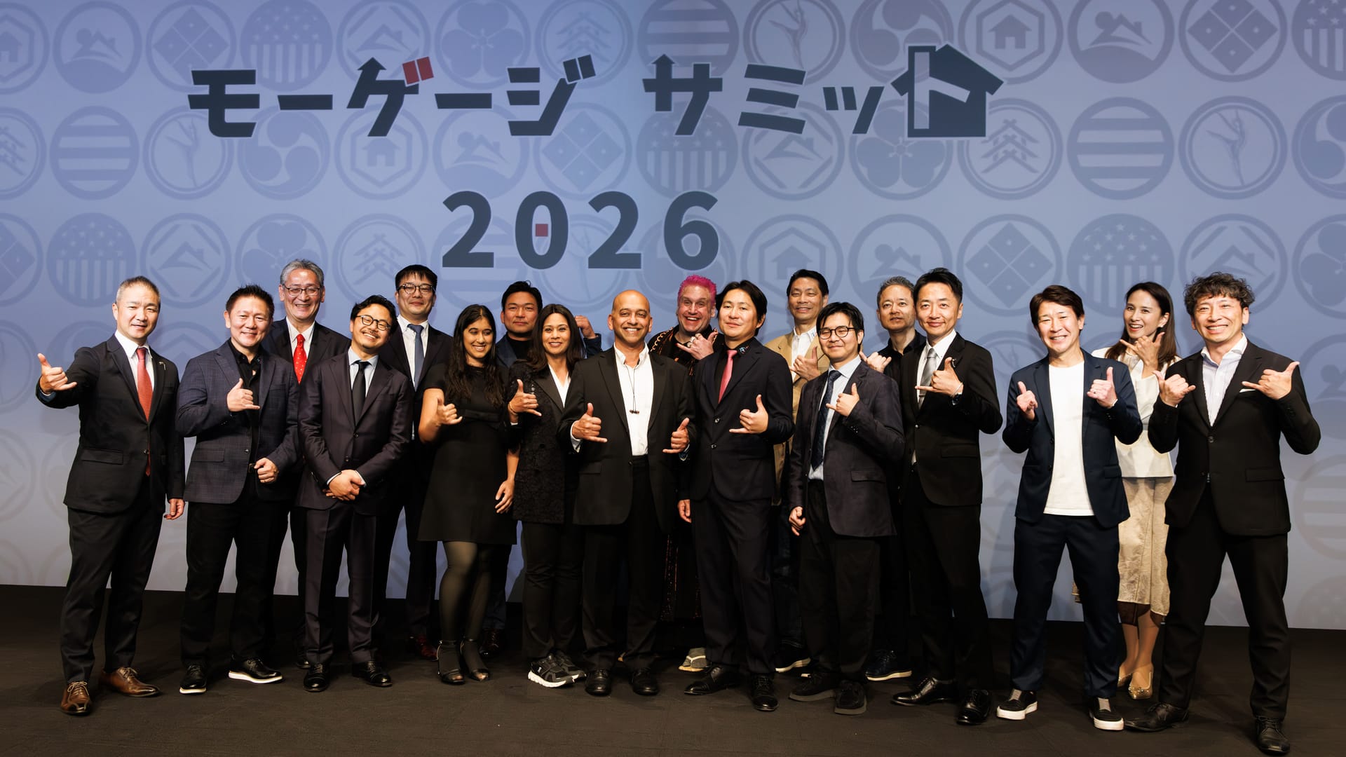バックドロップの前に並ぶ運営スタッフと登壇者